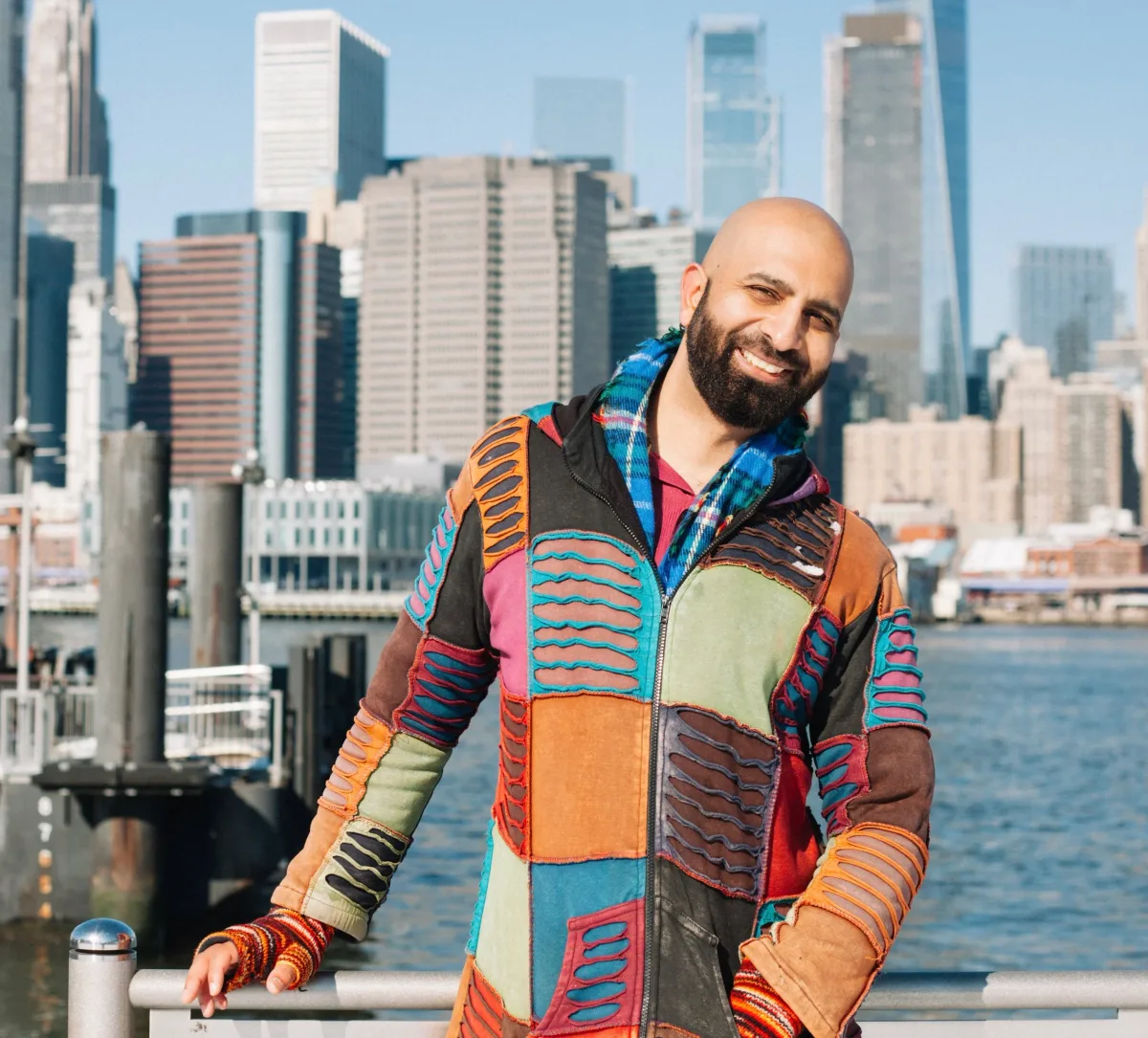 Fareed Quraishi standing outdoors in a jacket against an open sky.